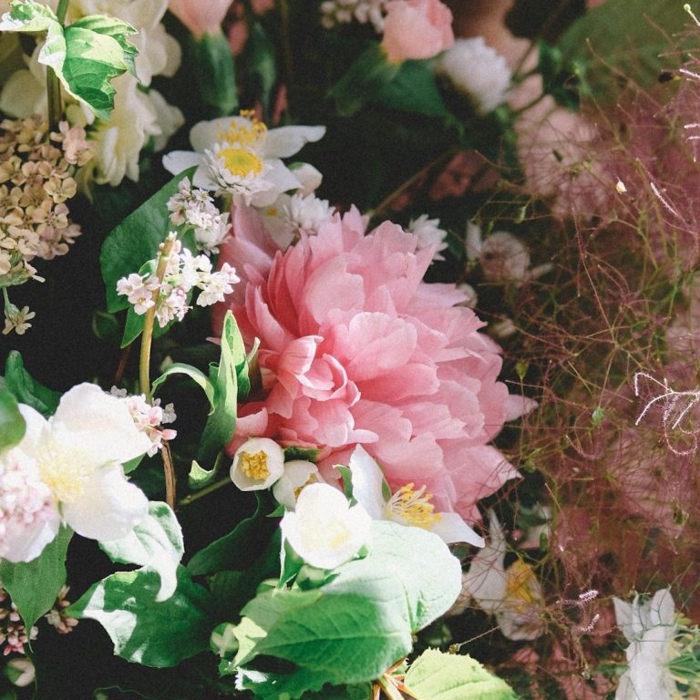 British flowers A variety of colourful flowers, including pink peonies and white blooms, surrounded by greenery.